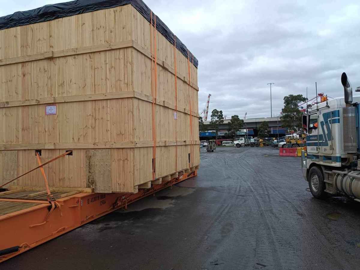 wood crate with shrink wrap cap on top of crate