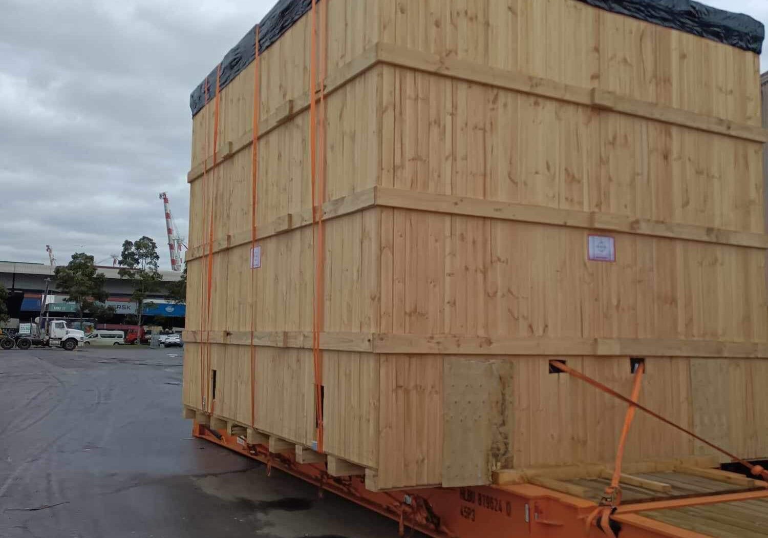 wooden crate strapped to a shipping container
